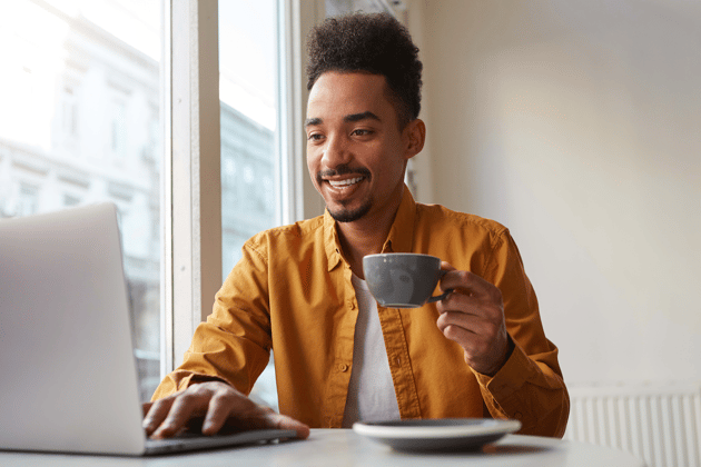 Man smiling at computer