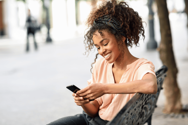 Woman smiling at phone