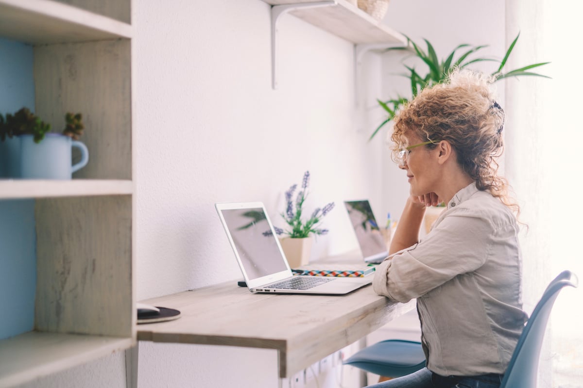 woman-working-at-home-with-laptop-on-desktop-works-2021-12-09-02-49-36-utc